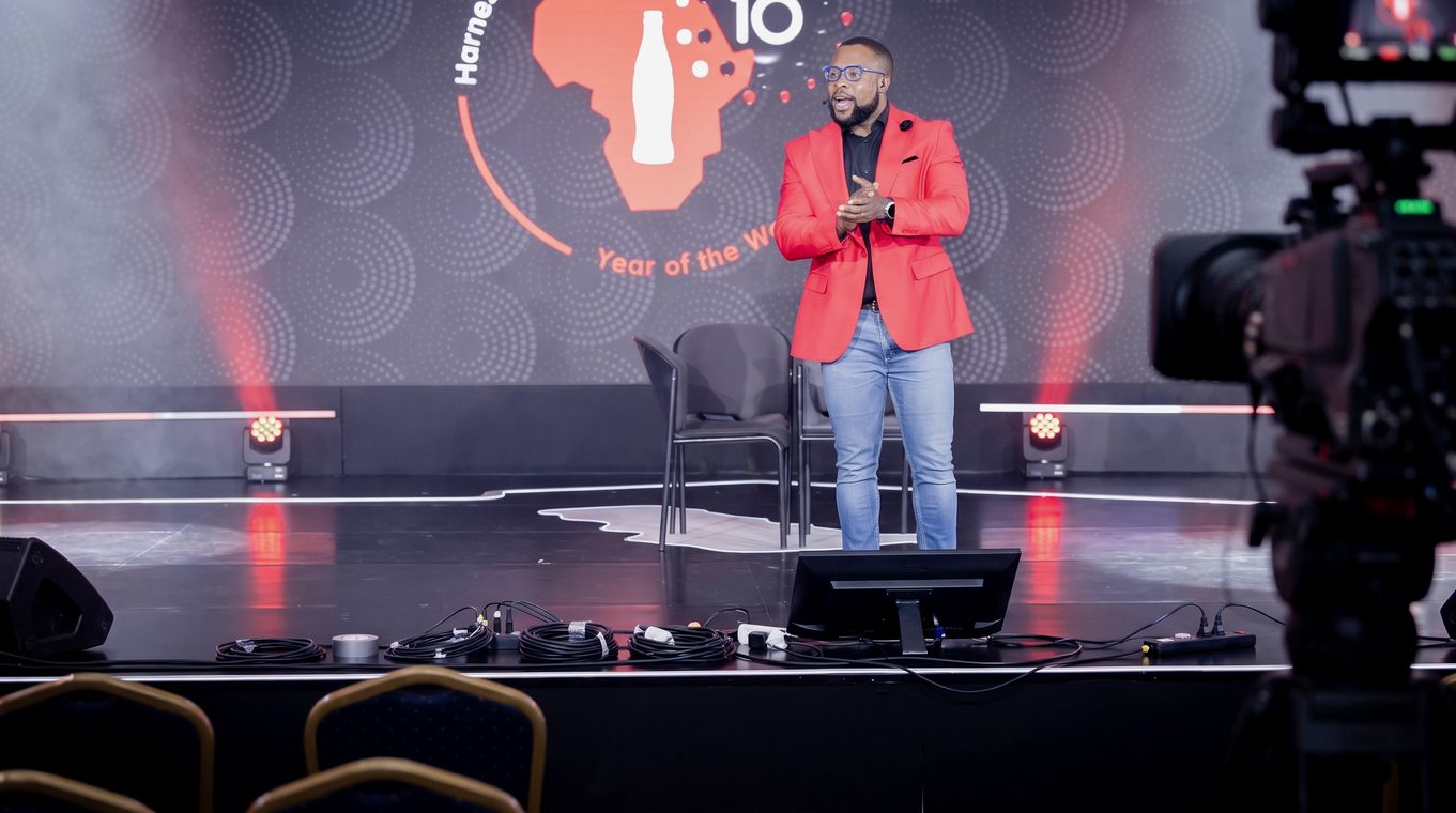 Alone on stage, broadcast camera in frame
